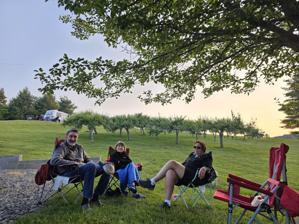 Friends hanging out in camping chairs at Fancy Gap Cabins and Campground